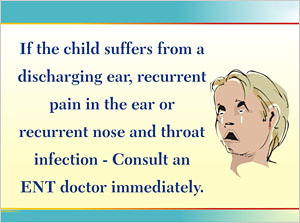 A child who is crying and is holding his ear. He seems to be having pain in the ear.