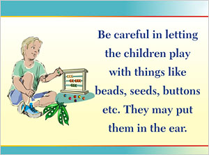 A child playing with beads and pea seeds which can be inserted in the ear as foreign bodies.